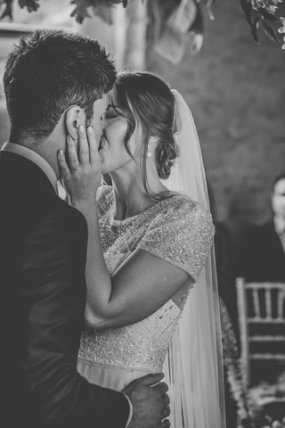 bride and groom share first kiss in ceremony